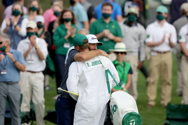 Dustin Johnson celebrates with his brother and caddie Austin Johnson on the 18th green winning the 2020 Masters Tournament Sunday, Nov. 15, 2020, at Augusta National. (Curtis Compton / Curtis.Compton@ajc.com)