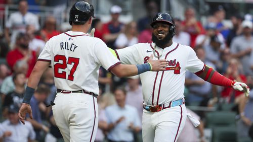 Braves slugger Marcell Ozuna (right) celebrates his three-run homer with Austin Riley during the first inning against the Boston Red Sox Wednesday at Truist Park. Staff photo by Jason Getz / AJC