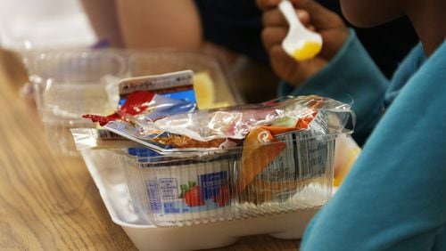 A student enjoys lunch in the Aloma Elementary School in Winter Park, Fla. The district encourages kids to put items from the school lunch they know they will not eat on a “share table” so others can have them, if they want. RICARDO RAMIREZ BUXEDA / ORLANDO SENTINEL