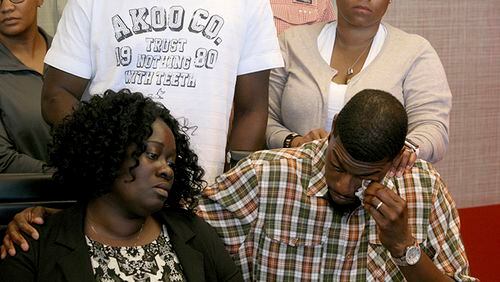 Odell Edwards wipes away tears as he sits with his wife, Charmaine Edwards, listening to their attorney Lee Merritt talking about the death of their son, Jordan Edwards, in a police shooting Saturday in Balch Springs, Texas, in Merritt's law office in Dallas, Monday, May 1, 2017. A suburban Dallas police chief said Monday that his department wrongly described why an officer fired into a moving vehicle and killed Jordan Edwards, after an attorney for the boy's family said officers were trying to "justify the unjustifiable."
