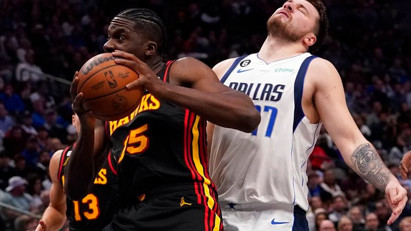 Atlanta Hawks center Clint Capela (15) gets past Dallas Mavericks guard Luka Doncic (77) on the way to the basket during the second half of an NBA basketball game in Dallas, Wednesday, Jan. 18, 2023. Hawks won 130-122. (AP Photo/LM Otero)
