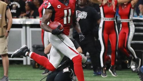Falcons wide receiver Julio Jones looks over his shoulder on his way to the end zone for the game-winning touchdown.  Curtis Compton/ccompton@ajc.com
