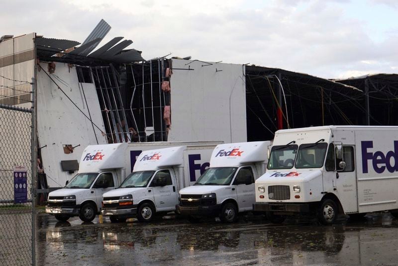 FedEx trucks sit outside a damaged FedEx facility after a tornado in Portage, Mich., Tuesday, May 7, 2024. (Brad Devereaux/Kalamazoo Gazette via AP)