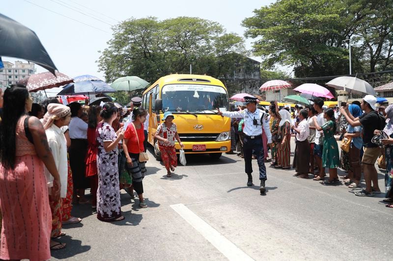 A bus carrying released prisoners is welcomed by family members and colleagues after leaving Insein Prison Wednesday, April 17, 2024, in Yangon, Myanmar. Myanmar’s jailed former leader Aung San Suu Kyi has been moved from prison to house arrest as a health measure due to a heat wave, the military government said. On Wednesday it also granted amnesty for over 3,000 prisoners to mark this week’s traditional New Year holiday. (AP Photo/Thein Zaw)
