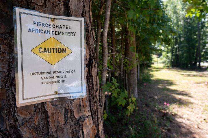 A small sign marks the Pierce Chapel African Cemetery in Midland, outside of Columbus. The cemetery was rediscovered in 2019 and work has since been done to clean, document and preserve it. The cemetery was reconsecrated during a Juneteenth celebration Monday, June 20, 2022. Ben Gray for the Atlanta Journal-Constitution
