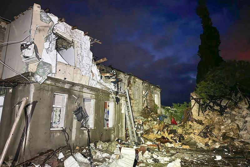 This photo, provided by head of the Odesa Regional Military Administration Oleh Kiper, firefighters work on the site of a damaged building after a Russian drone attack in Odesa, Ukraine, Tuesday, April 23, 2024. (Head of the Odesa Regional Military Administration Oleh Kiper via AP)