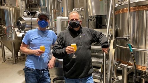 Director of Brewing Operations Mark Edelson (right) and head brewer Alex Vanderlek are at Iron Hill Brewery & Restaurant in Buckhead. Bob Townsend for The AJC