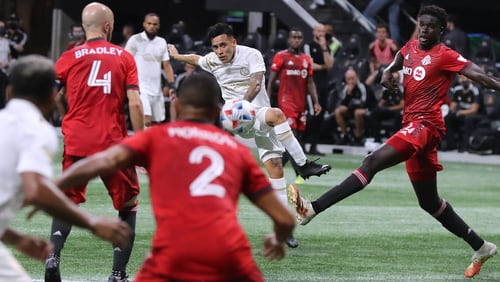 081821 Atlanta: Atlanta United midfielder Ezequiel Barco, who had the only goal of the match, takes a shot on goal through multiple Toronto FC defenders during the second half in a MLS soccer match on Wednesday, August 18, 2021, in Atlanta.   ���Curtis Compton / Curtis.Compton@ajc.com���