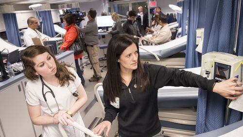 Nurse Kristy Haynes, right, shows resident nurse Brittany Evans around Carolinas MED-1, a mobile medical facility outside of the Marcus trauma and emergency room at Grady Memorial Hospital, on Monday, Jan. 29, 2018.The facility houses 14 extra emergency room beds and has an operable emergency operating room. ALYSSA POINTER/ALYSSA.POINTER@AJC.COM