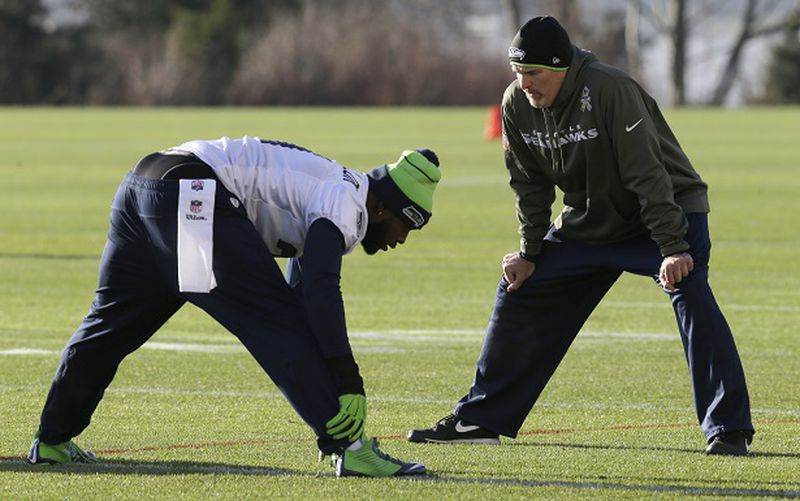 Seattle Seahawks strong safety Kam Chancellor, left, talks with defensive coordinator Dan Quinn, right, during warmups before NFL football practice Wednesday, Jan. 14, 2015 in Renton, Wash. The Seahawks will face the Green Bay Packers Sunday in the NFC Championship game. (AP Photo/Ted S. Warren) Alas, this same personnel won't be available here. (AP photo/Ted S. Warren)
