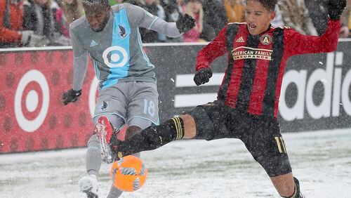 Minnesota United midfielder Kevin Molino and Atlanta United midfielder Yamil Asad battles for the ball during the first half of an MLS soccer match Sunday, March 12, 2017, in Minneapolis, (Elizabeth Flores/Star Tribune via AP)