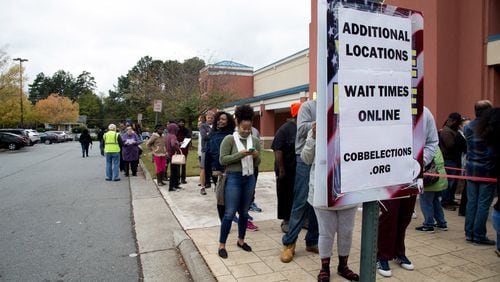 People wait in a long line to vote at the Cobb County Board of Elections and Registration office in Marietta Saturday, Oct. 27, 2018. STEVE SCHAEFER / SPECIAL TO THE AJC