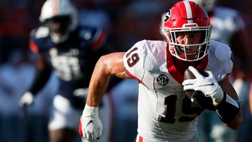 Georgia tight end Brock Bowers (19) carries the ball after a reception during the second half of an NCAA football game against Auburn, Saturday, Sept. 30, 2023, in Auburn, Ala. Bowers is a possible first round pick in the NFL Draft. (AP Photo/Butch Dill, File)