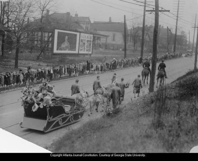 In this 1920s photo, kids of all ages line an Atlanta street to see St. Nick parade past. The reindeer pulling the sleigh may have found the pavement a little different from snow, but they handled it like pros.