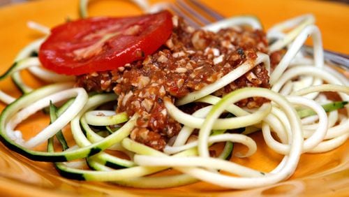Spicy spaghetti sauce atop zucchini pasta. The sauce is made of sundried tomatoes, cashews, fresh tomatoes and select other raw, uncooked ingredients.