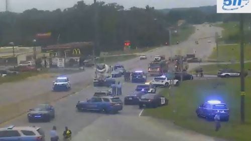 At least a dozen law enforcement vehicles could be seen surrounding a dark pickup truck at the Ga. 140/Folsom Road exit from I-75 in Bartow County.