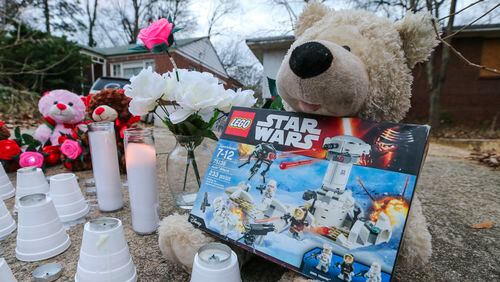 A memorial was placed near where a boy was killed and a girl was injured early in a pit bull attack on their way to school. Logan Braatz and Syari Sanders were walking to a bus stop when they were mauled. Parents of both children have filed suit. AJC FILE PHOTO