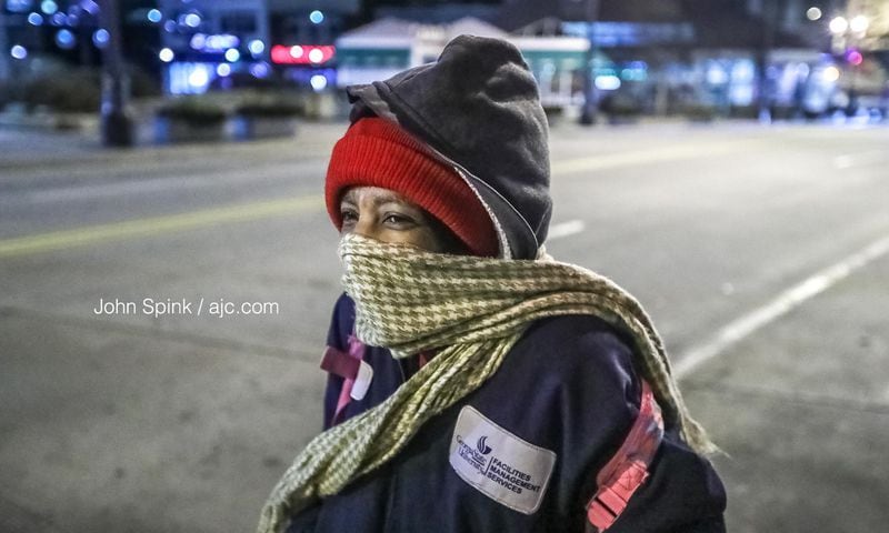 With temperatures in the 20s Tuesday morning, Corine Riley made sure to bundle up as she stood on Peachtree and Wall streets in downtown Atlanta.