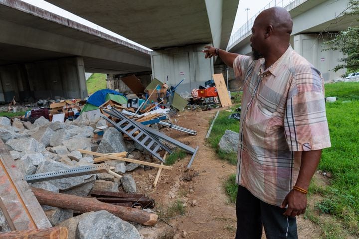 Thomas Lecky, 41, speaks about wood and other items he’s collected to build a shelter at a homeless encampment in downtown Atlanta on Thursday, August 25, 2022. The city and the nonprofit Partners for HOME plan to shut down the encampment before Labor Day and find housing for the residents. It’s taken several weeks for Lecky to collect the items, he says. “It helps keep me sane to have a routine.” (Arvin Temkar / arvin.temkar@ajc.com)