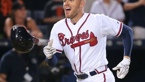 Freddie Freeman reacts after hitting a walk-off home run in the eleventh inning for a June 1 win against San Francisco at Turner Field. (Curtis Compton/AJC file photo)
