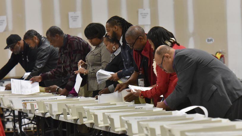 Workers recount the votes cast in the Atlanta mayoral election runoff at the Fulton County Elections Preparation Center on Thursday. HYOSUB SHIN / HSHIN@AJC.COM
