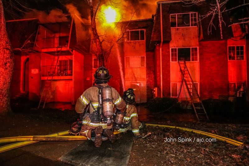 About 45 firefighters responded to an apartment fire on Pine Tree Circle in DeKalb County. JOHN SPINK / JSPINK@AJC.COM