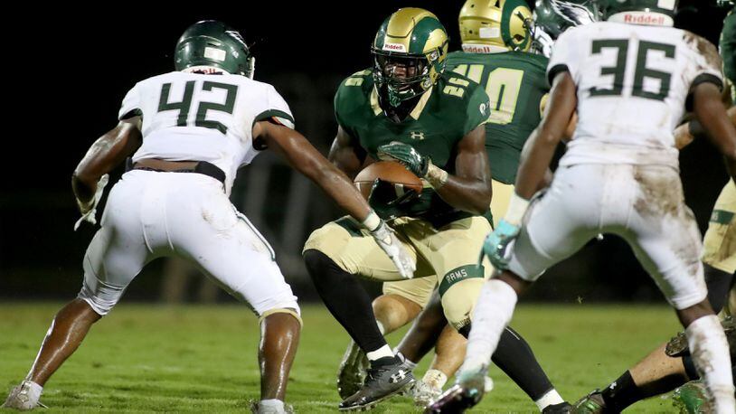 Grayson running back Phil Mafah (26) runs against Collins Hill linebacker Logan Birdsong (42) in the first half at Grayson High School Friday, September 18, 2020 in Loganville, Ga..(Jason Getz/Special to the AJC)