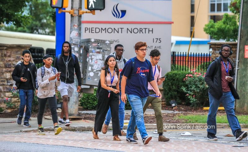 Students return to Georgia State University in downtown Atlanta Monday morning hours after university police officers exchanged gunfire with a man near a housing complex. JOHN SPINK / JSPINK@AJC.COM