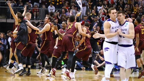 Loyola players celebrate beating Kansas State 78-62 in the South regional final at Philips Arena Saturday night.