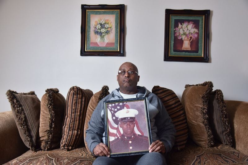 Bernard Hodore, a Marine veteran who served at Camp Lejeune in the 1980s, holds a photograph of himself at his home in Decatur. Hodore is a member of the Lejeune Community Assistance Panel. He has neurobehavorial conditions he blames on toxic water from the base. HYOSUB SHIN / HSHIN@AJC.COM