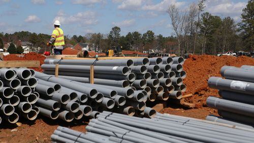 A  worker watches over the construction of Brumby Elementary School in Marietta, on March 10, 2017.  Cobb County residents will vote whether to extend its education SPLOST, and some south Cobb residents have expressed concerns over the way the money was distributed in the past,  complaining it favored wealthier schools. (HENRY TAYLOR / HENRY.TAYLOR@AJC.COM)