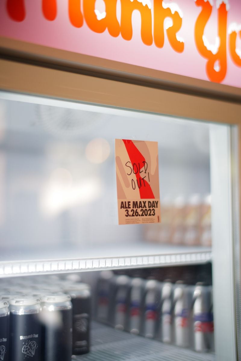 A sticker alerts the crowd that all cans of the original Ale Max Day collaboration craft beer with Inner Voice Brewing were sold out on March 26, 2023. (John R. Walder)