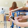 Schools have realized they’ve lost the battle for student attention to the ubiquitous smartphone. Yet many hesitate to ban the phones outright. (Dreamstime/TNS)