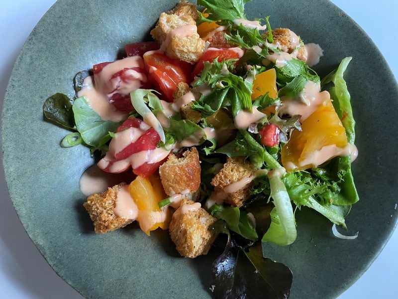 Leon’s panzanella salad features heirloom tomatoes, focaccia croutons, Tucker Farms greens and Pearson Farm peach vinaigrette. CONTRIBUTED BY BOB TOWNSEND