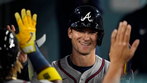 Atlanta Braves' Luke Williams returns to the dugout after scoring off of a sacrifice fly hit by Orlando Arcia during the tenth inning of a baseball game against the Los Angeles Dodgers in Los Angeles, Friday, May 3, 2024. (AP Photo/Ashley Landis)