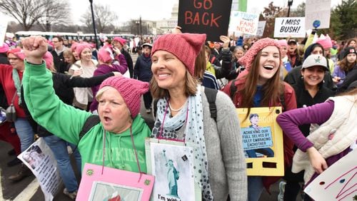 January 21, 2017 Washington D.C. - A group from Decatur, from left, Kay Hinton and Lynn Adams, and Katie Adams, 18, walk toward the U.S. Capitol for the Women’s March on Washington on Saturday, January 21, 2017. They rode a bus overnight to participate this event. The Women’s March on Washington is a grassroots effort comprised of dozens of independent coordinators at the state level. HYOSUB SHIN / HSHIN@AJC.COM