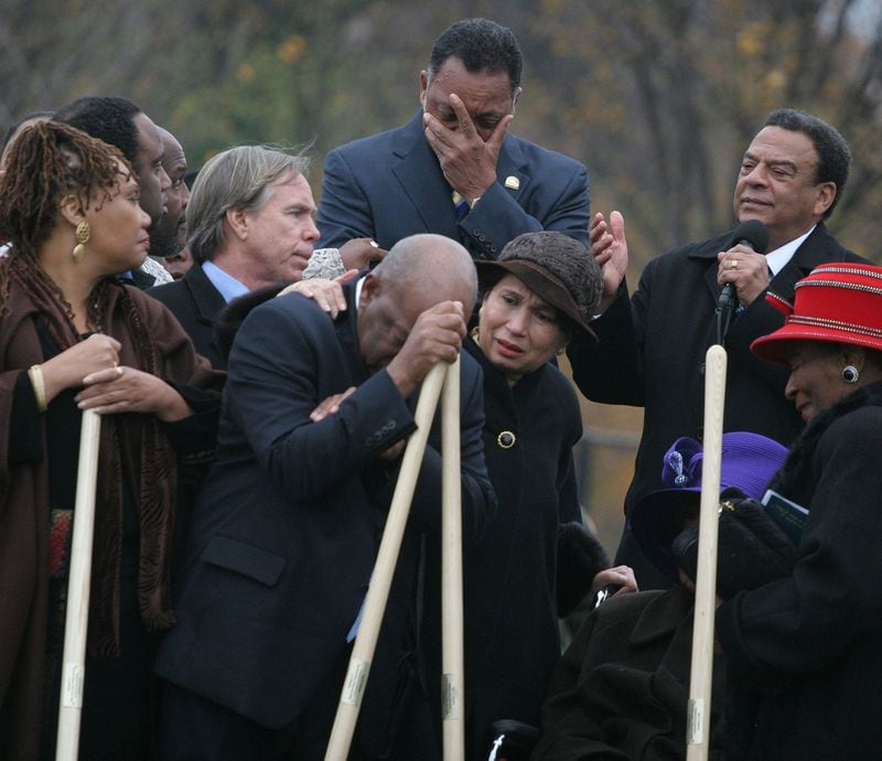 Rep. John Lewis becomes emotional during the groundbreaking ceremony for the Martin Luther King Memorial on the National Mall in Washington on Nov. 13, 2006. Others surrounding Lewis are, from left, Yolanda King, fashion designer Tommy Hilfiger, Rev. Jesse Jackson, former Labor Secretary Alexis Herman, Amb. Andrew Young and Martin Luther King Jr.'s sister Christine King Farris. (Lauren Victoria Burke / AP file)