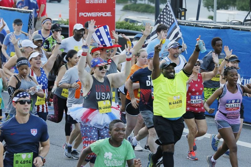 In this file photo, non-elite runners at the starting line. BOB ANDRES /BANDRES@AJC.COM