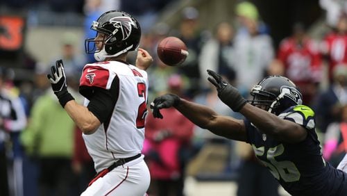 Seattle Seahawks defensive end Cliff Avril, right, forces a fumble by Atlanta Falcons quarterback Matt Ryan (2) in the first half of an NFL football game, Sunday, Oct. 16, 2016, in Seattle. The Seahawks recovered the fumble.. (AP Photo/Stephen Brashear)