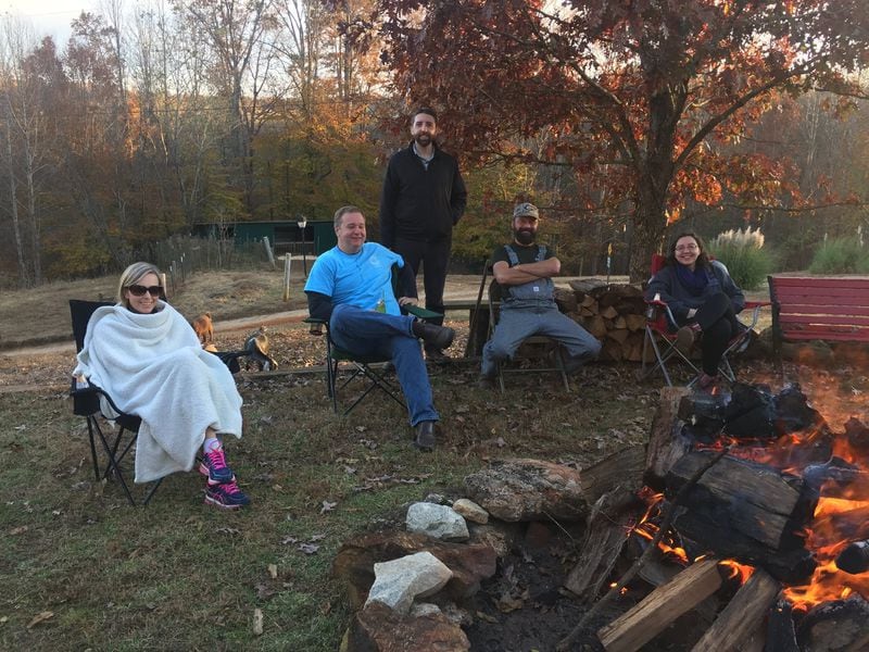 Family members sit around the bonfire at the Thanksgiving celebration hosted by Maggie and Richard Johnson. CONTRIBUTED BY JENNY ROBB-KING