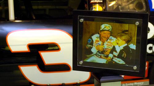 A photo of Dale Earnhardt and Wessa Miller, a little girl with spina bifida he met through the Make-A-Wish Foundation, the day she gave him a penny, which he glued to the dashboard of the No. 3 Chevrolet he used to win the 1998 Daytona 500. The penny is still glued to the dashboard of the car on display at the Richard Childress Racing Museum in Welcome, N.C. (Davie Hinshaw/Charlotte Observer/TNS)