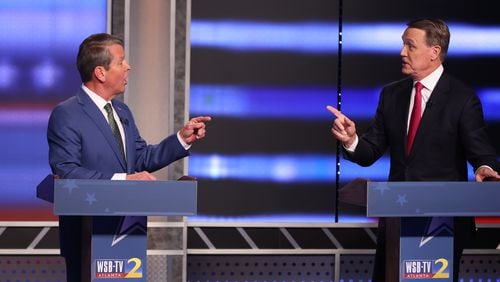 From the start of the debate, Governor Brian Kemp (left) had to defend himself from constant attacks from the former Sen David Perdue during the first debate of the Republican primary for governor on Sunday, April 24, 2022. (Miguel Martinez/Atlanta Journal Constitution/TNS)