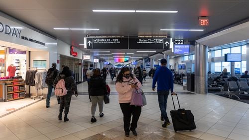 Travelers are seen moving through Hartsfield Jackson International Airport in Atlanta, Georgia on January 16th, 2022.