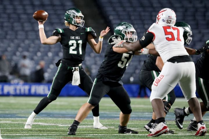 Collins Hill quarterback Sam Horn (21) attempts a pass against Milton during the first half of the Class 7A state title football game at Georgia State Center Parc Stadium Saturday, December 11, 2021, Atlanta. JASON GETZ FOR THE ATLANTA JOURNAL-CONSTITUTION