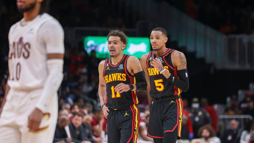 Atlanta Hawks guard Trae Young (11) and guard Dejounte Murray (5) talk as a teammate attempts a free-throw during the first half against the Cleveland Cavaliers at State Farm Arena, Friday, Feb. 24, 2023, in Atlanta. Jason Getz / Jason.Getz@ajc.com)