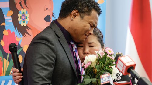 (Left to right) Robert Peterson, son of Yong Ae Yue,  a victim of the March 16 shooting, is embraced by Bonnie Youn after speaking during the Asian Americans Rise Against Hate event at Georgia Freight Depot in Atlanta on Thursday, March 16, 2023. March 16 marks the two year anniversary of the Atlanta spa shootings that took the lives of eight people including six Asian Americans. (Natrice Miller/ natrice.miller@ajc.com) (Natrice Miller/ natrice.miller@ajc.com)