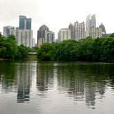 The skyline of Midtown is visible from Piedmont Park on Friday, June 11, 2021. (Christine Tannous / christine.tannous@ajc.com)