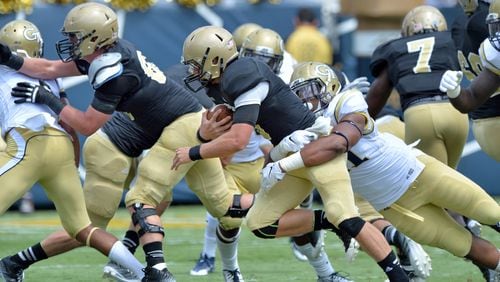 August 30, 2014 Atlanta - Wofford Terriers quarterback Evan Jacks (3) gets tackled from behind by Georgia Tech Yellow Jackets defensive lineman Patrick Gamble (91) in the first half of the Georgia Tech season opener at Bobby Dodd Stadium on Saturday, August 30, 2014. HYOSUB SHIN / HSHIN@AJC.COM