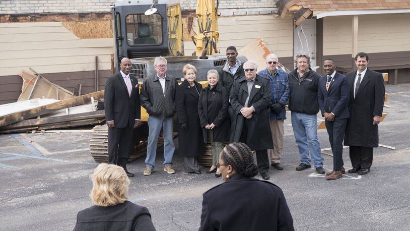01/16/2018 — Jonesboro, GA - City leaders of Jonesboro, including mayor Joy Brantley Day, third from left, and the city manager, Ricky Clark, Jr., second from right, pose for a photo following the demolition of buildings along Broad Street in downtown Jonesboro, Tuesday, January 16, 2018. The city of Jonesboro is hoping to attract its residence and entice its visitors by upping its downtown revitalization efforts. They will start the process by tearing down a row of dilapidated buildings on Broad Street. ALYSSA POINTER/ALYSSA.POINTER@AJC.COM