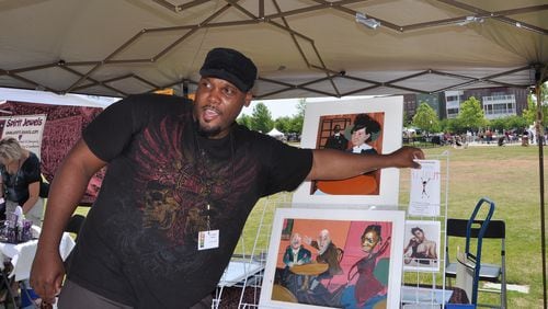 Artist and Illustrator R. Gregory Christie, of Mableton, distributes brochures about his art, children's books and website at Suwanee Town Center Park on May 21, 2011.
